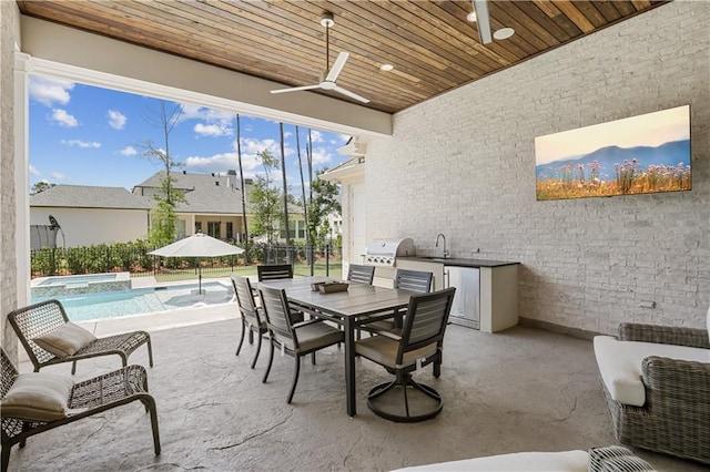 128 Juniper Ct, Mandeville, LA 70471 - view of patio / terrace featuring an outdoor kitchen, a ceiling fan, outdoor dining space, and a pool with connected hot tub