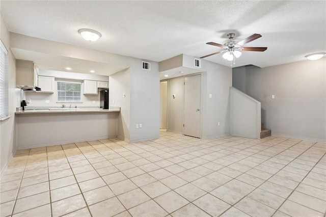 429 Cedarwood Dr Unit 429, Mandeville, LA 70471 - unfurnished living room featuring stairs, a ceiling fan, and a textured ceiling