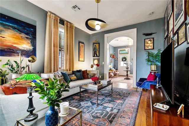 1808 N Rampart St, New Orleans, LA 70116 - living area with wood finished floors and arched walkways