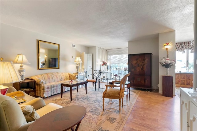 1550 2nd St Unit 4A, New Orleans, LA 70130 - living room featuring a textured ceiling and light wood-style flooring