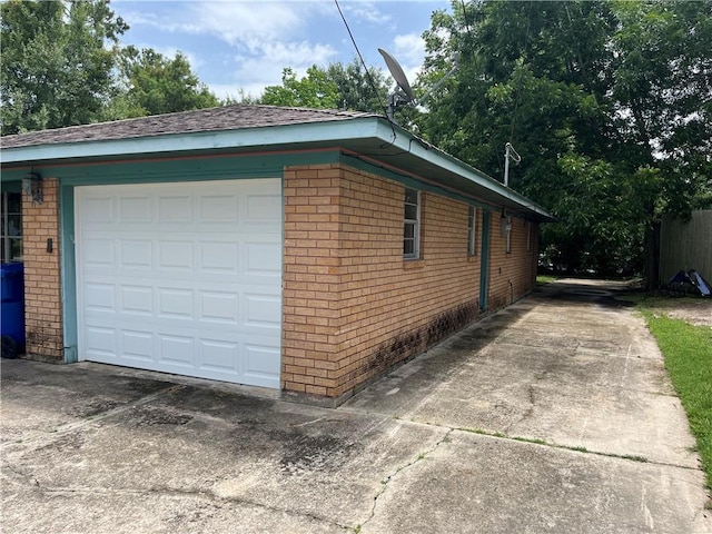 3062 S Palm Dr, Slidell, LA 70458 - view of side of property with brick siding, driveway, and a garage