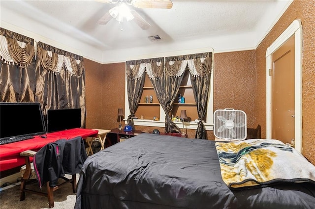 1018 Reynes Dr, New Orleans, LA 70117 - carpeted bedroom with a textured wall and a ceiling fan