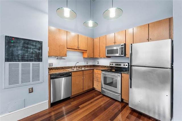 920 Poeyfarre St Unit 161, New Orleans, LA 70131 - kitchen featuring appliances with stainless steel finishes, dark countertops, dark wood-type flooring, hanging light fixtures, and a high ceiling