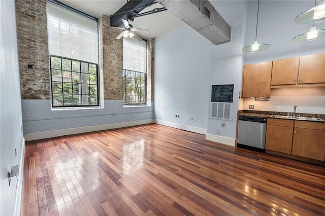 920 Poeyfarre St Unit 161, New Orleans, LA 70131 - kitchen featuring stainless steel dishwasher, dark wood-style floors, dark countertops, a ceiling fan, and a high ceiling