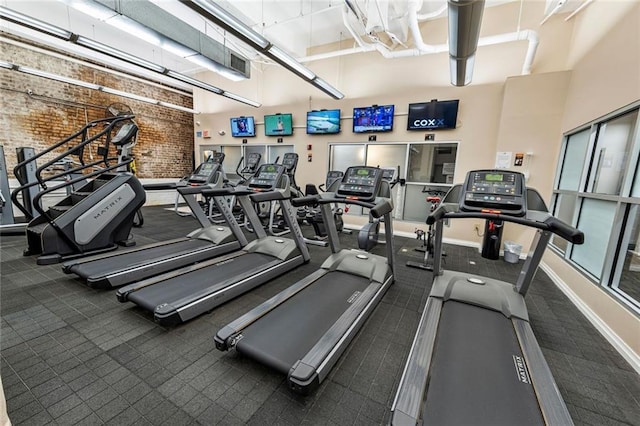 920 Poeyfarre St Unit 161, New Orleans, LA 70131 - workout area with a high ceiling, brick wall, and carpet