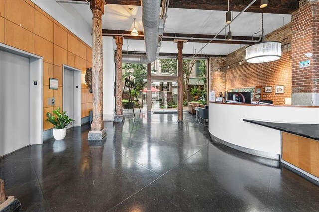 920 Poeyfarre St Unit 161, New Orleans, LA 70131 - reception area featuring a high ceiling, brick wall, floor to ceiling windows, and ornate columns