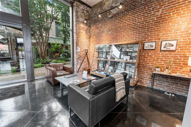 920 Poeyfarre St Unit 161, New Orleans, LA 70131 - living room with a high ceiling and brick wall
