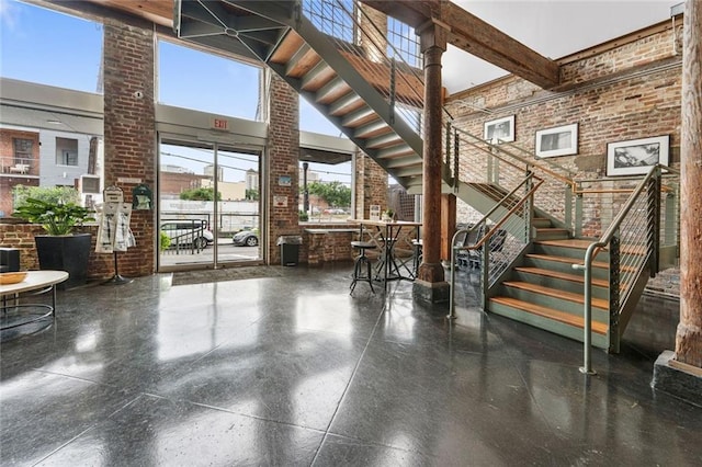 920 Poeyfarre St Unit 161, New Orleans, LA 70131 - community lobby featuring a high ceiling, brick wall, and stairs