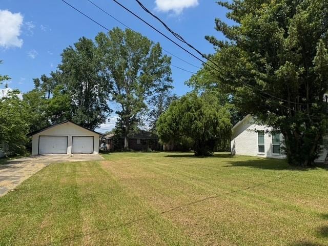 372 W 5th St, La Place, LA 70068 - view of grassy yard featuring a garage and an outbuilding