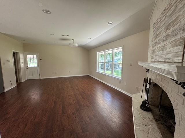 372 W 5th St, La Place, LA 70068 - unfurnished living room featuring dark wood-style floors and a brick fireplace