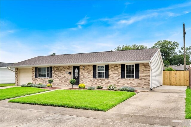 566 Welham Loop, La Place, LA 70068 - ranch-style house with concrete driveway, brick siding, an attached garage, and roof with shingles