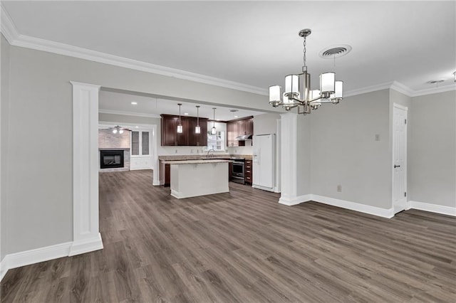 566 Welham Loop, La Place, LA 70068 - kitchen with open floor plan, a kitchen island, dark wood finished floors, crown molding, and a chandelier