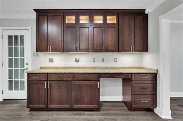 566 Welham Loop, La Place, LA 70068 - kitchen with ornamental molding, wood finished floors, light stone counters, built in study area, and glass insert cabinets