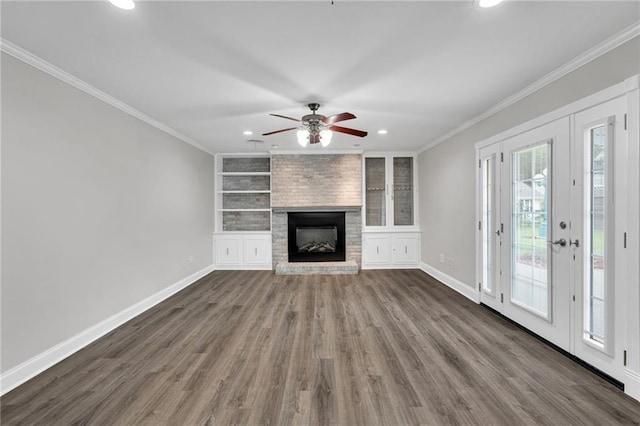 566 Welham Loop, La Place, LA 70068 - unfurnished living room featuring crown molding, dark wood-type flooring, a ceiling fan, recessed lighting, and a large fireplace