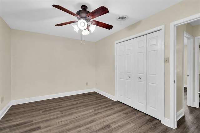 566 Welham Loop, La Place, LA 70068 - unfurnished bedroom with dark wood-style flooring, a closet, and a ceiling fan