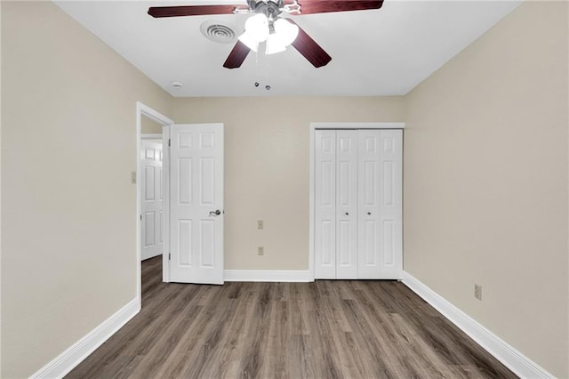 566 Welham Loop, La Place, LA 70068 - unfurnished bedroom featuring wood finished floors, a closet, and ceiling fan