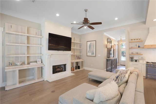1537 Darlington St, Covington, LA 70433 - living area featuring ceiling fan, wood finished floors, crown molding, a high end fireplace, and recessed lighting