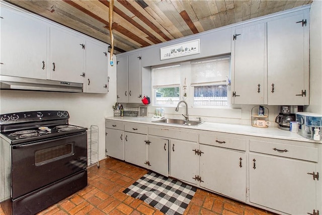 507 Elm St, Amite, LA 70422 - kitchen featuring black electric range oven, under cabinet range hood, brick patterned floors, light countertops, and wood ceiling