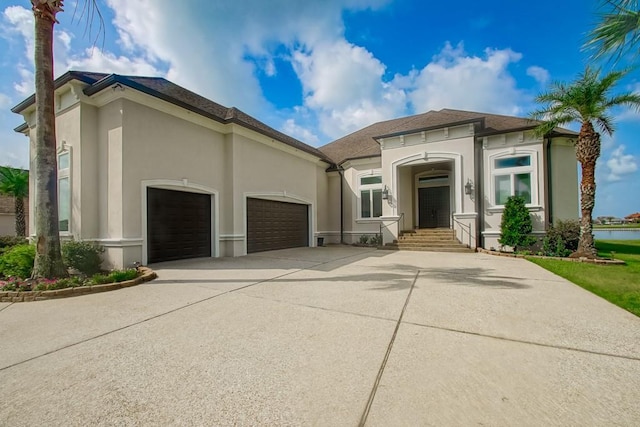 3012 Sunrise Blvd, Slidell, LA 70461 - mediterranean / spanish home featuring concrete driveway, a garage, stucco siding, and a shingled roof