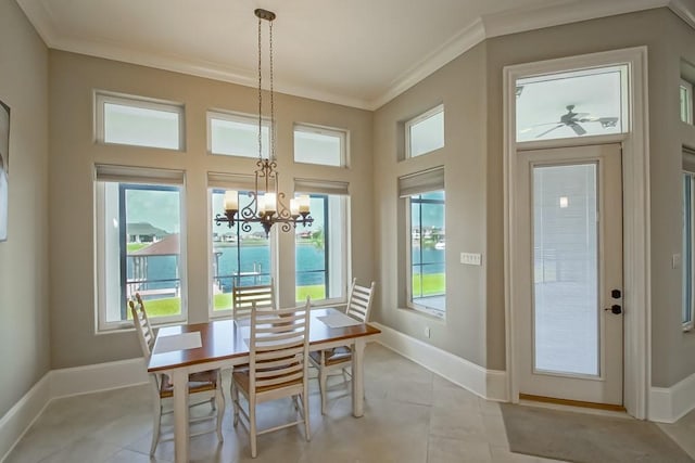 3012 Sunrise Blvd, Slidell, LA 70461 - dining room featuring crown molding, healthy amount of natural light, light tile patterned floors, and a chandelier