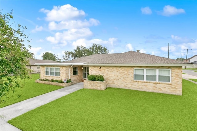 701 Mehle St, Arabi, LA 70032 - ranch-style house with a front yard, brick siding, and a shingled roof