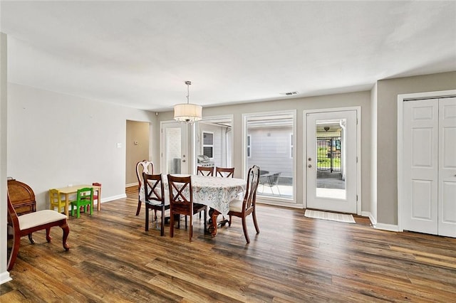 701 Mehle St, Arabi, LA 70032 - dining room featuring dark wood finished floors and a chandelier