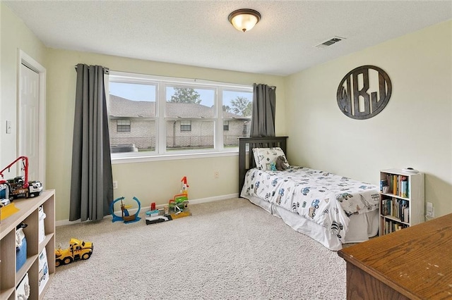 701 Mehle St, Arabi, LA 70032 - carpeted bedroom featuring a textured ceiling and baseboards