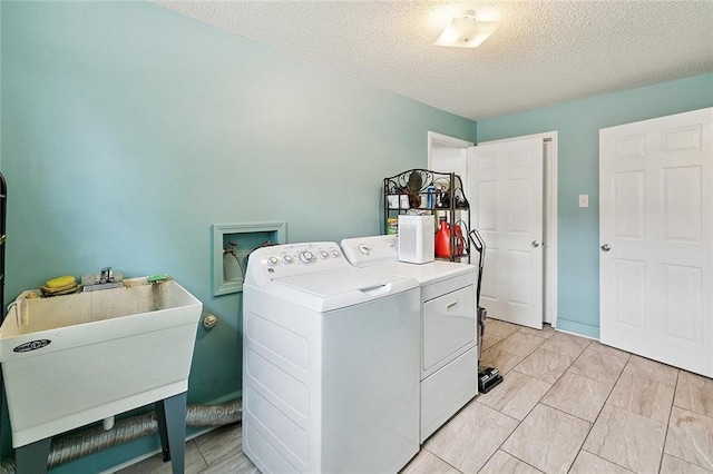 701 Mehle St, Arabi, LA 70032 - laundry room with washing machine and dryer and a textured ceiling