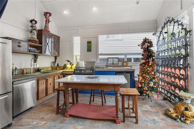 3705 Carondelet St, New Orleans, LA 70115 - kitchen with stainless steel appliances, stone tile flooring, open shelves, and wood ceiling