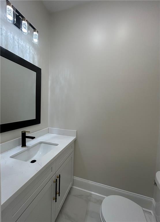 8111 Karen St, Metairie, LA 70003 - half bath featuring marble look tile flooring and vanity