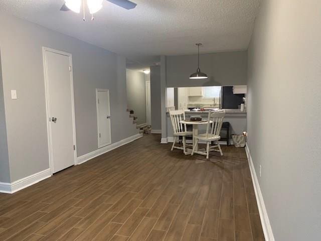 109 River Point Dr Unit E, Destrehan, LA 70047 - dining space with dark wood-type flooring, ceiling fan, a textured ceiling, and stairs