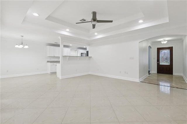 9962 E Wheaton Cir, New Orleans, LA 70127 - unfurnished living room with a raised ceiling, ceiling fan, arched walkways, recessed lighting, and a chandelier