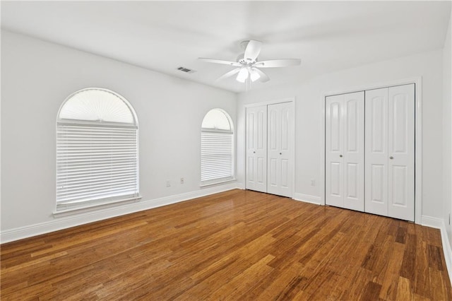 9962 E Wheaton Cir, New Orleans, LA 70127 - unfurnished bedroom with wood finished floors, multiple closets, and a ceiling fan