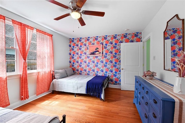 672729 Louis Xiv St, New Orleans, LA 70124 - bedroom featuring wallpapered walls, an accent wall, light wood-style flooring, and ceiling fan