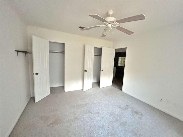 34050 Live Oak Ln, Slidell, LA 70460 - unfurnished bedroom featuring two closets, carpet flooring, and ceiling fan