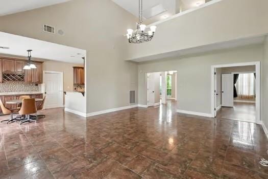 110 Woodchase Dr, Belle Chasse, LA 70037 - unfurnished living room with a chandelier and high vaulted ceiling