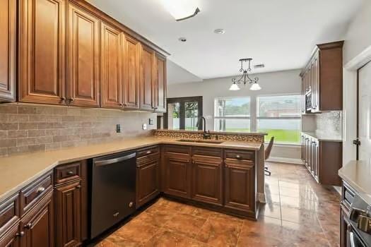 110 Woodchase Dr, Belle Chasse, LA 70037 - kitchen featuring dishwasher, light countertops, backsplash, and a peninsula