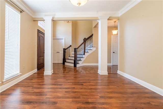 110 Woodchase Dr, Belle Chasse, LA 70037 - foyer entrance featuring decorative columns, ornamental molding, wood finished floors, and stairs