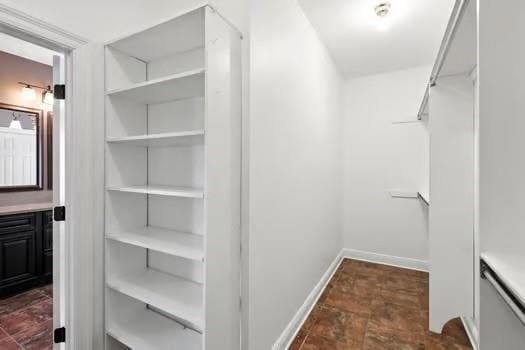 110 Woodchase Dr, Belle Chasse, LA 70037 - walk in closet with dark stone finish flooring