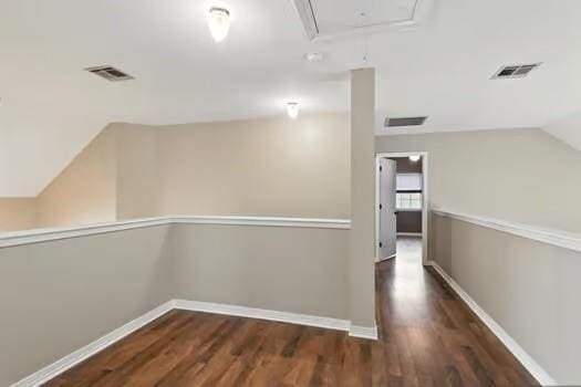 110 Woodchase Dr, Belle Chasse, LA 70037 - hall with attic access, wood finished floors, and lofted ceiling