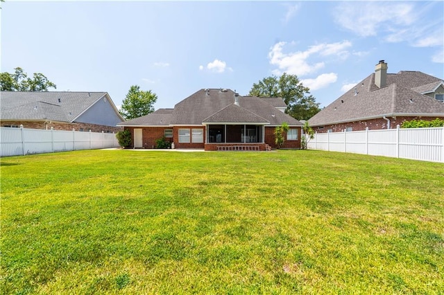 110 Woodchase Dr, Belle Chasse, LA 70037 - back of house featuring a sunroom and a fenced backyard