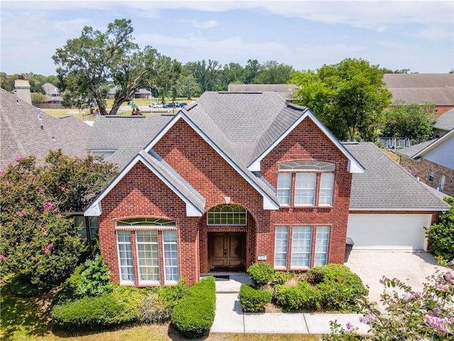110 Woodchase Dr, Belle Chasse, LA 70037 - traditional-style house with brick siding, an attached garage, concrete driveway, and roof with shingles