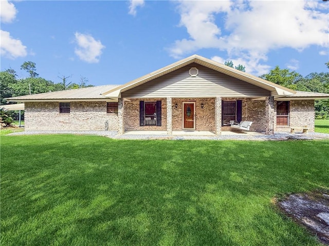 41449 N Charbonnet Rd, Ponchatoula, LA 70454 - view of front facade featuring a front yard, brick siding, and covered porch