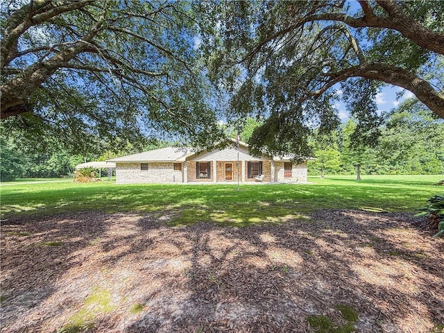 41449 N Charbonnet Rd, Ponchatoula, LA 70454 - ranch-style home with a front yard and a metal roof