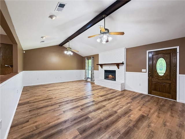41449 N Charbonnet Rd, Ponchatoula, LA 70454 - unfurnished living room with wainscoting, a ceiling fan, wood finished floors, and a brick fireplace