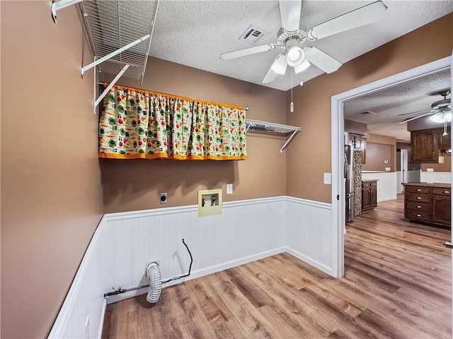 41449 N Charbonnet Rd, Ponchatoula, LA 70454 - laundry area with ceiling fan, a textured ceiling, wainscoting, hookup for a washing machine, and wood finished floors