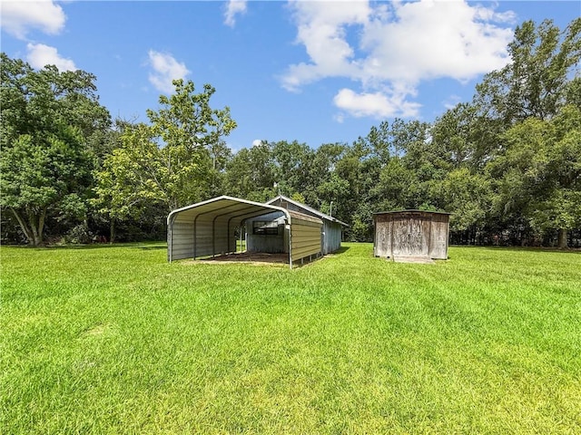 41449 N Charbonnet Rd, Ponchatoula, LA 70454 - view of grassy yard with a storage shed and a detached carport
