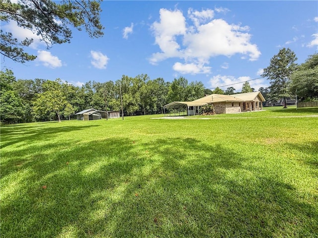 41449 N Charbonnet Rd, Ponchatoula, LA 70454 - view of green lawn with a carport