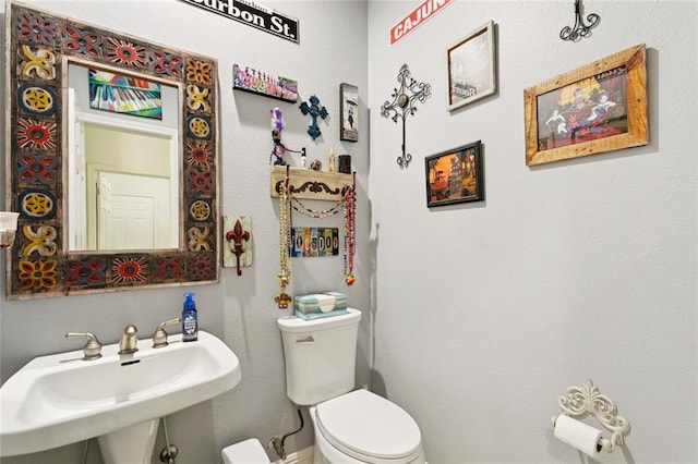 542 Huseman Ln, Covington, LA 70435 - half bathroom featuring a sink and toilet