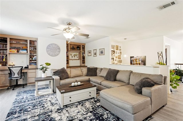 542 Huseman Ln, Covington, LA 70435 - living area with an office area, light wood finished floors, and a ceiling fan